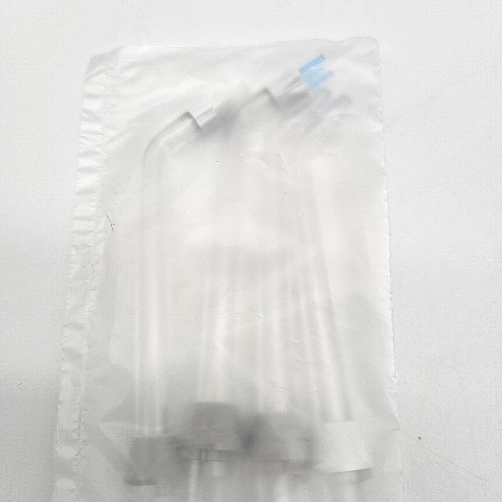 A clear plastic bag containing several Waterpik oral irrigator tips.