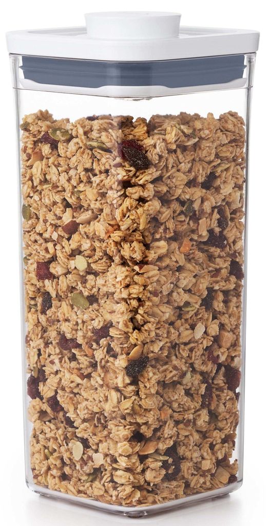 A clear, well-lit studio shot of a clear plastic food storage container filled with granola.