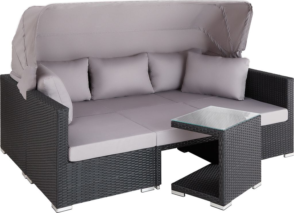 A grey rattan lounge sofa with a canopy and cushions, next to a small glass-topped table.