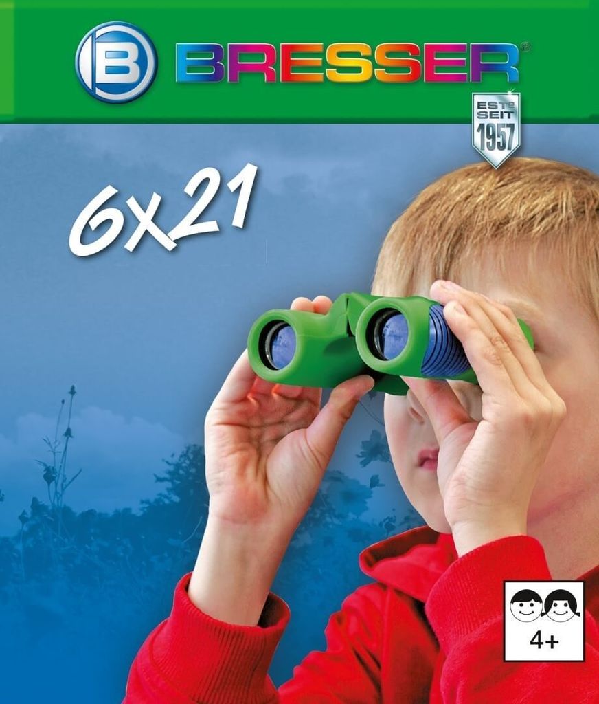 A child is looking through green binoculars against a blurred blue and green background.