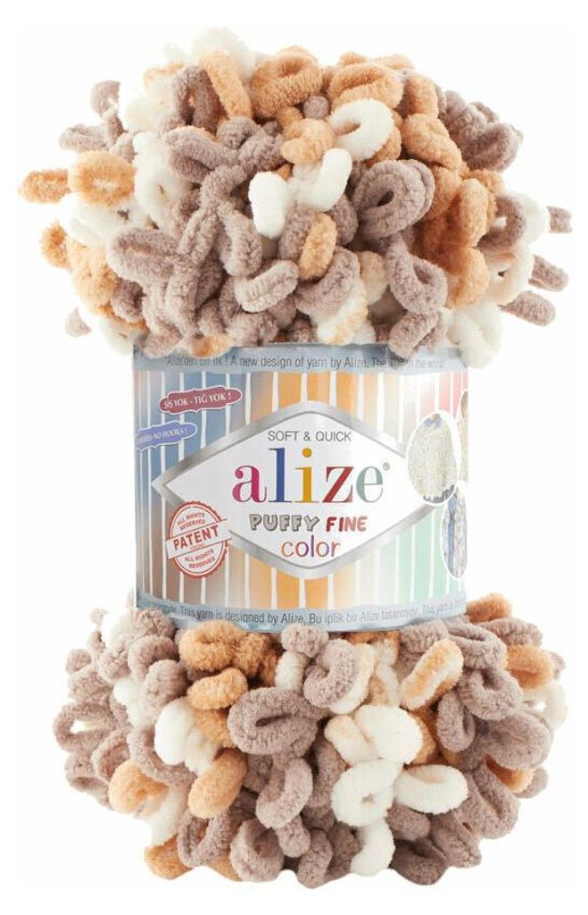 A spool of Alize Puffy Fine Color yarn with loops of yarn extending from the top and bottom.