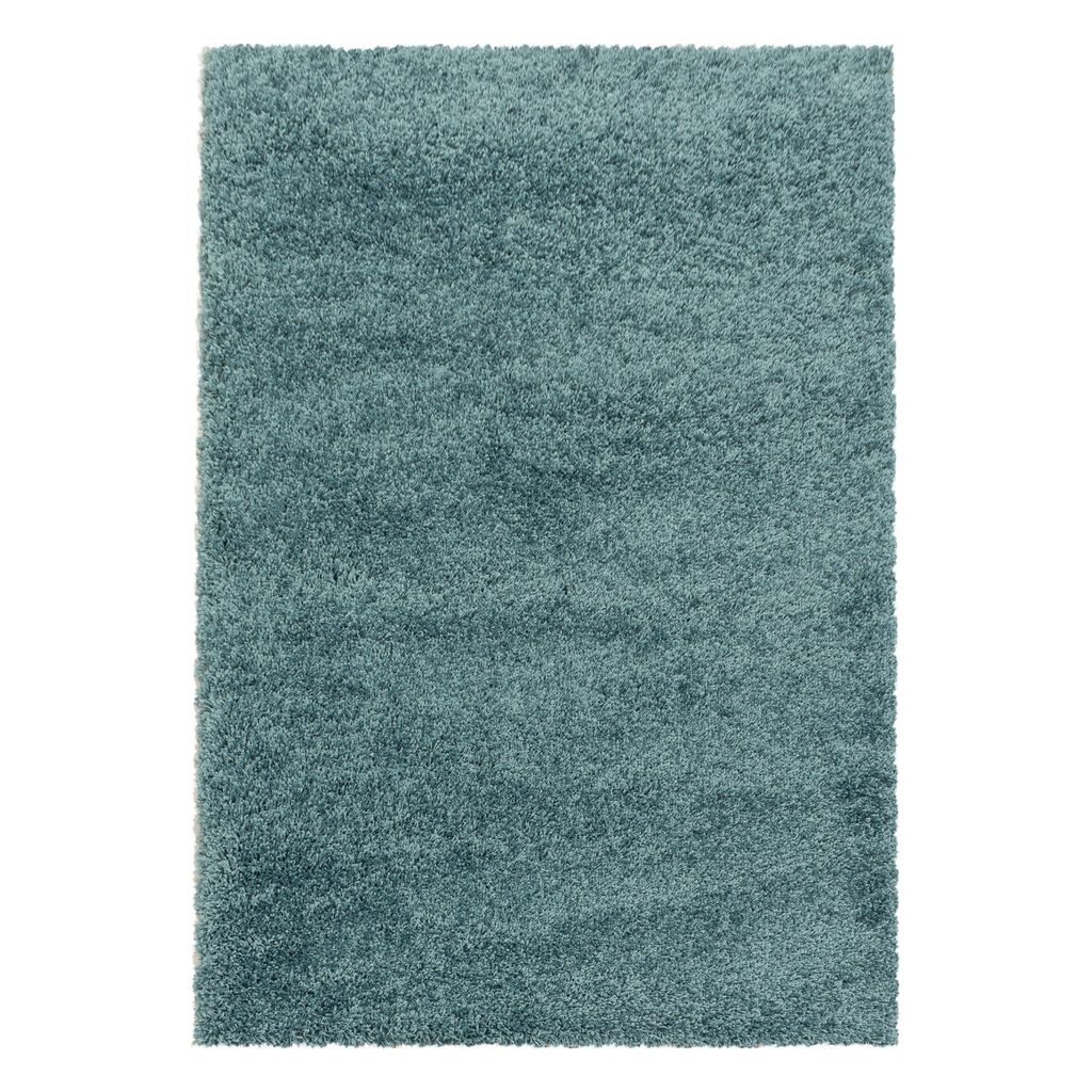 A rectangular shaggy rug in a teal color.