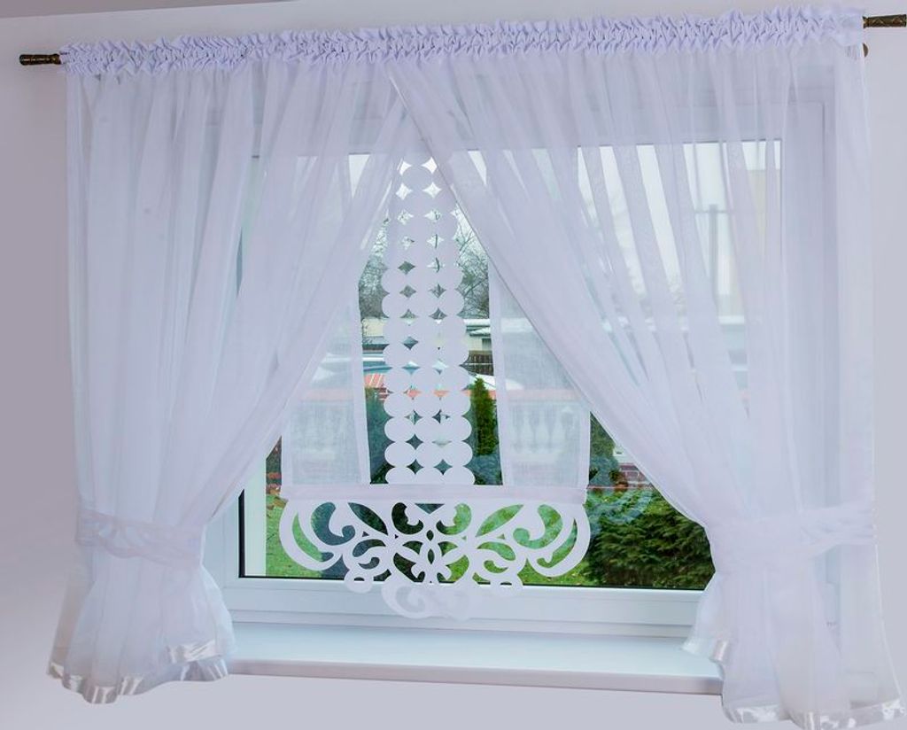 A white sheer curtain is displayed on a window.