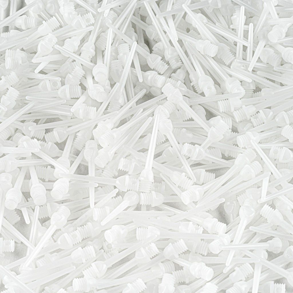 A pile of white dart tips.