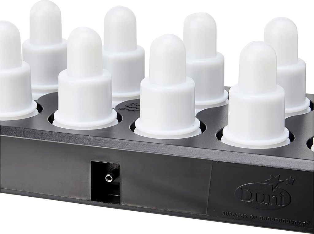 A close-up, angled view of a black charging base with multiple white LED tea lights inserted.