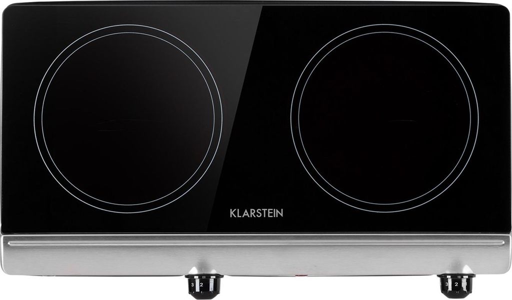 A modern, black glass ceramic cooktop with two heating elements and a silver base.