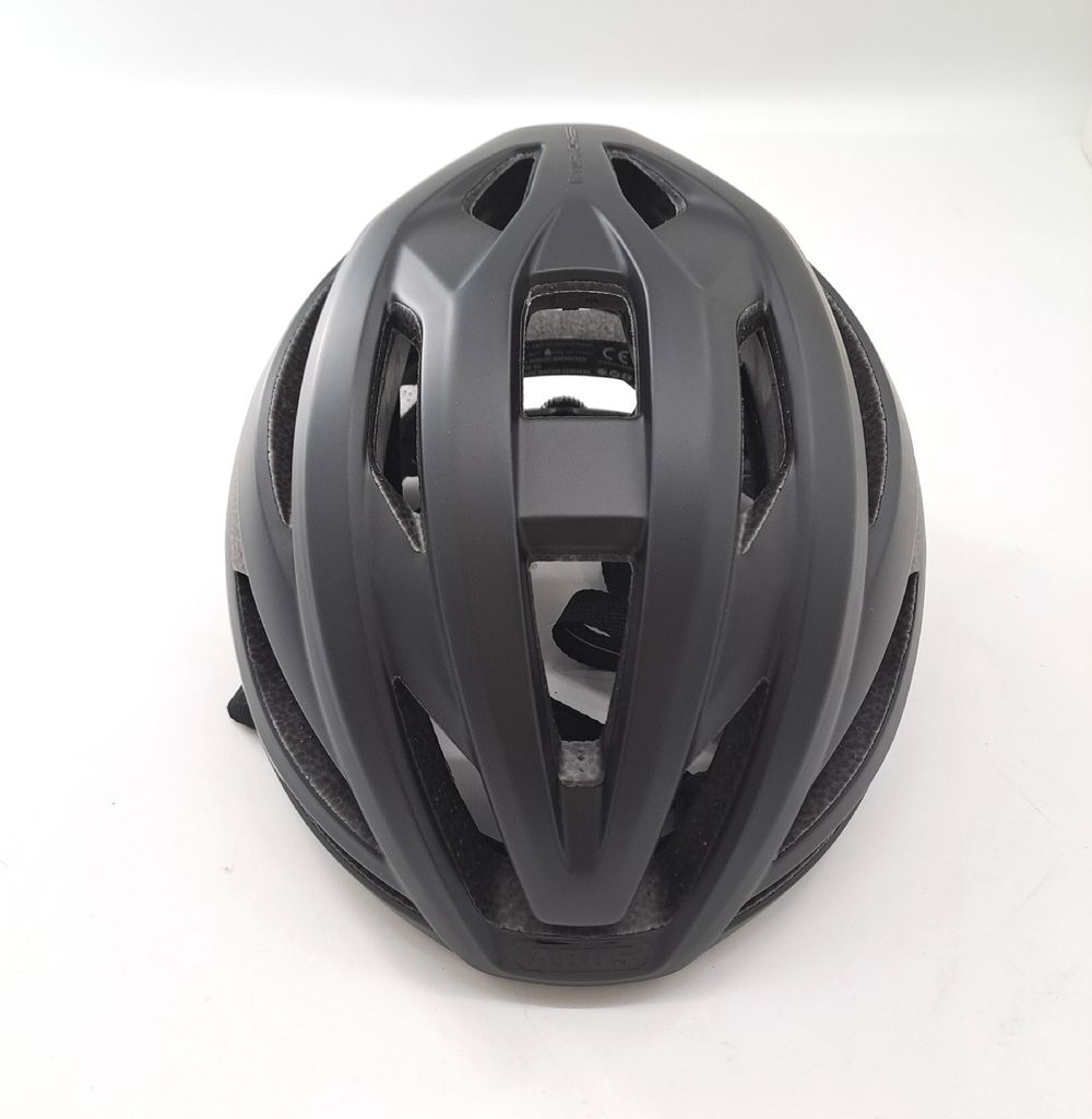 A black bicycle helmet is shown from a top-down perspective against a white background.