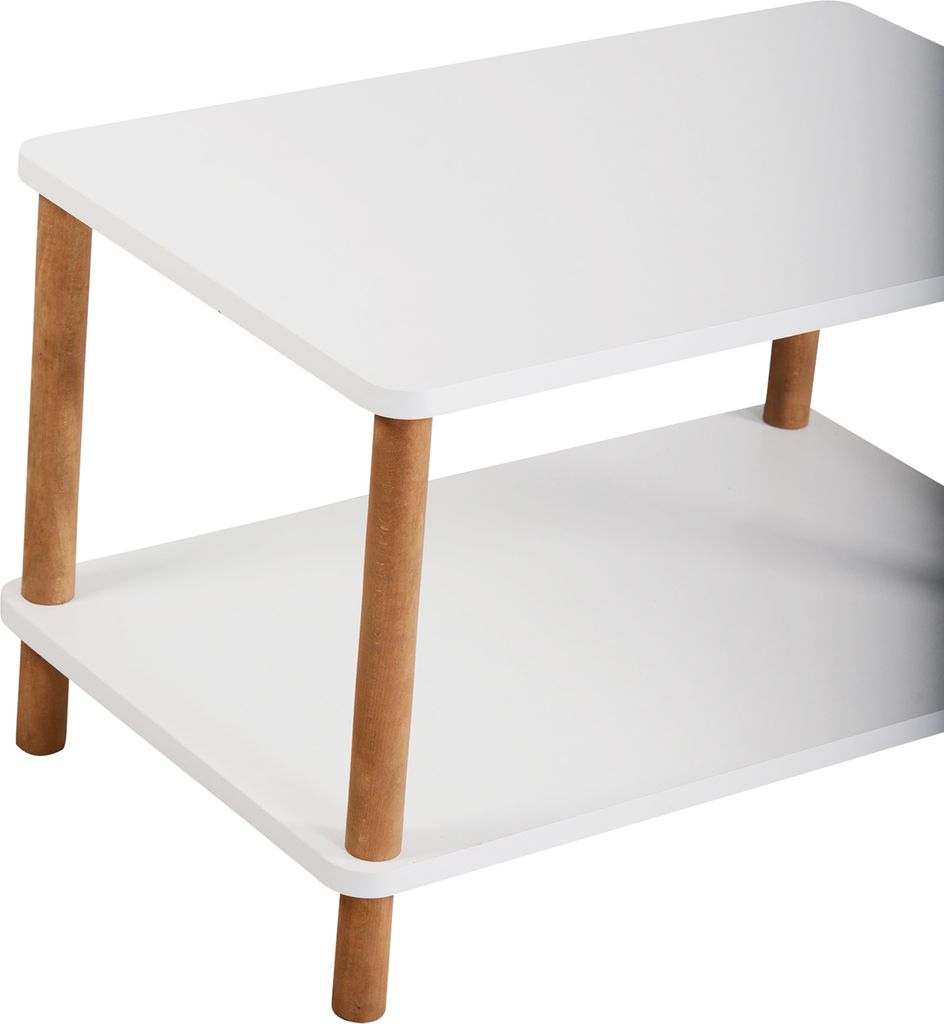 A close-up view of a white, two-tiered coffee table with wooden legs.
