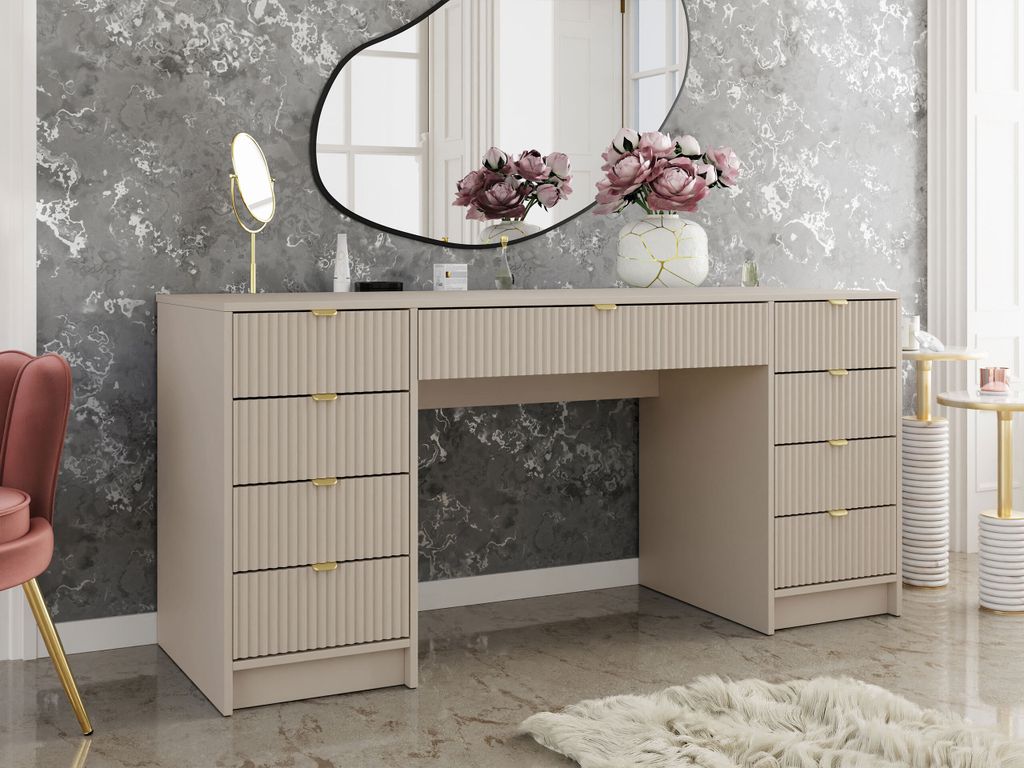 A vanity table with drawers and a mirror in a bedroom setting.
