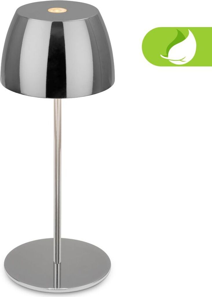 A modern, cordless LED table lamp with a chrome finish is presented against a white background. A green leaf icon is visible in the upper right corner.