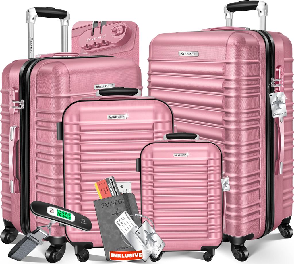 A set of four pink suitcases of varying sizes, arranged in a group. Accessories like a passport, tickets, and a luggage scale are placed in front of the suitcases.