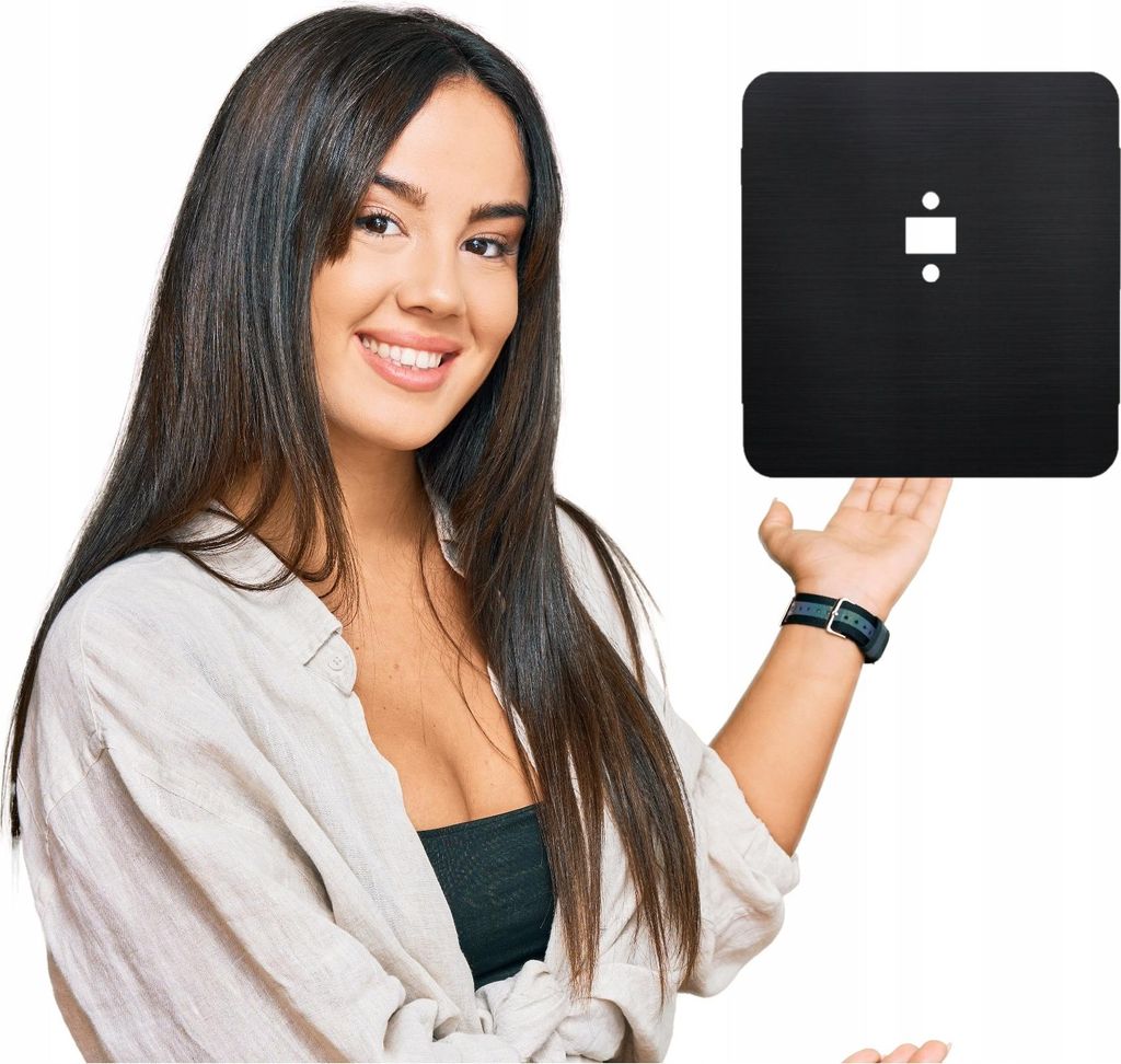A woman is presenting a black square object.