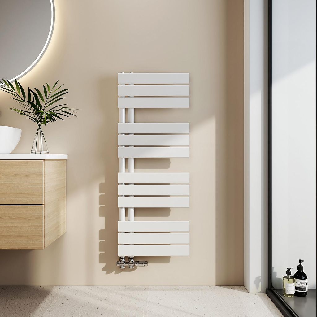 A modern bathroom setting with a white towel radiator mounted on a beige wall.