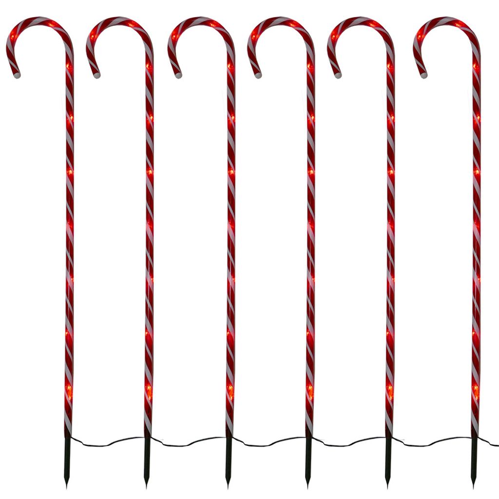 Six illuminated candy cane garden stakes arranged in a row against a white background.