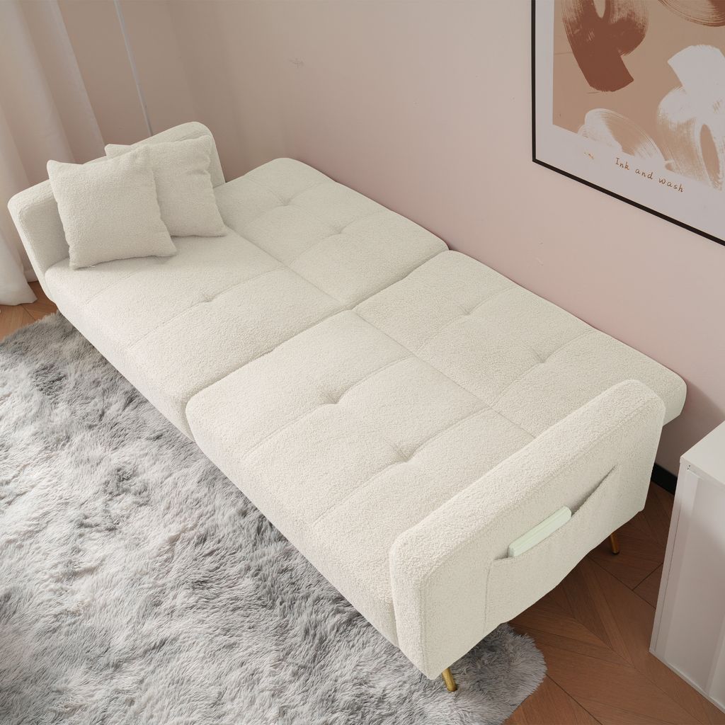 A white sofa bed is shown in a room with a pink wall and a grey rug.