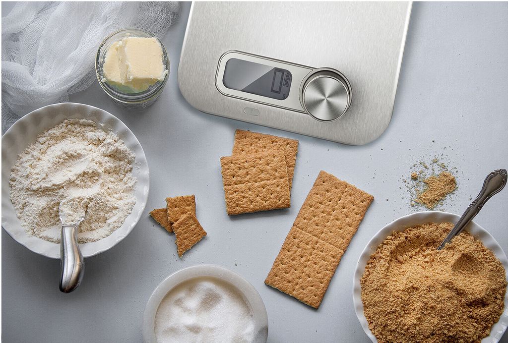 A top-down view of baking ingredients and a kitchen scale.