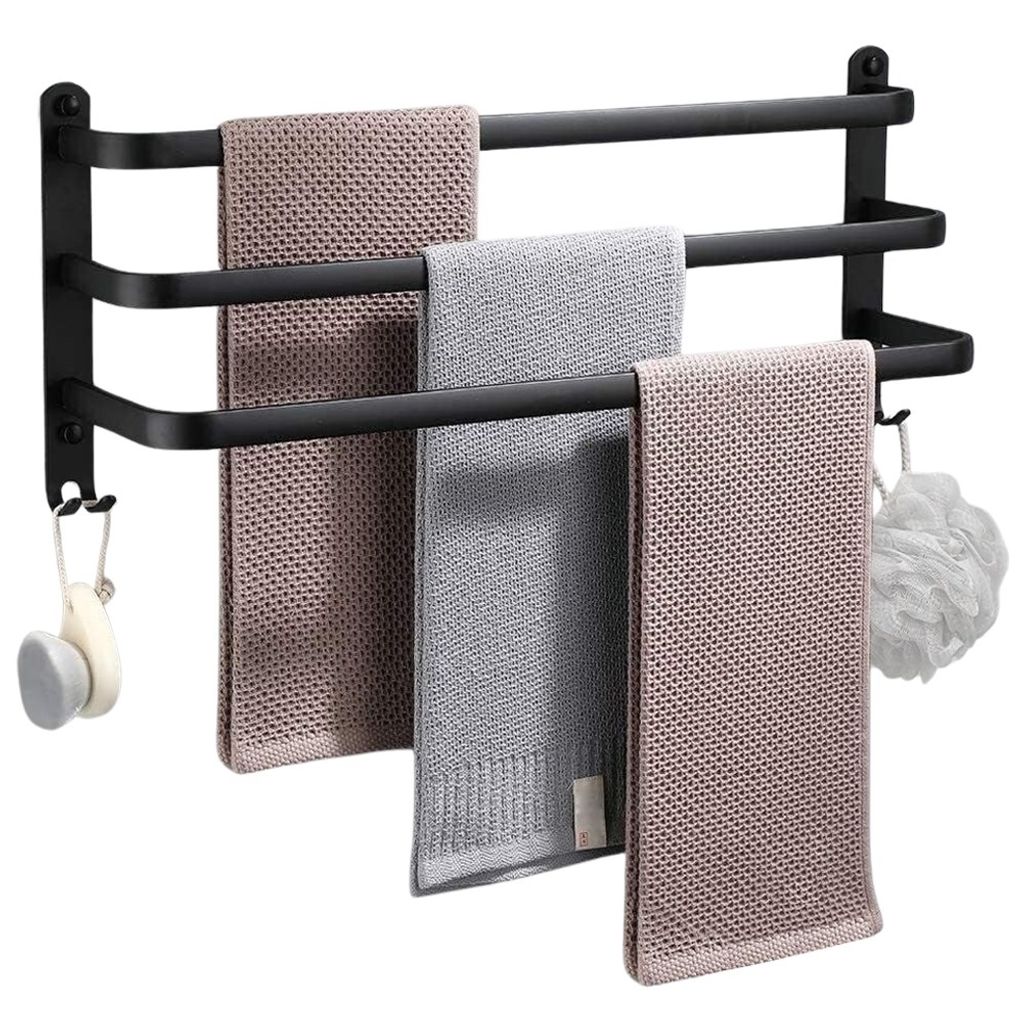 A black aluminum towel rack with three bars, holding three folded towels and a bath puff.