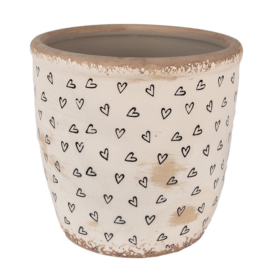 A beige ceramic pot with black heart designs.