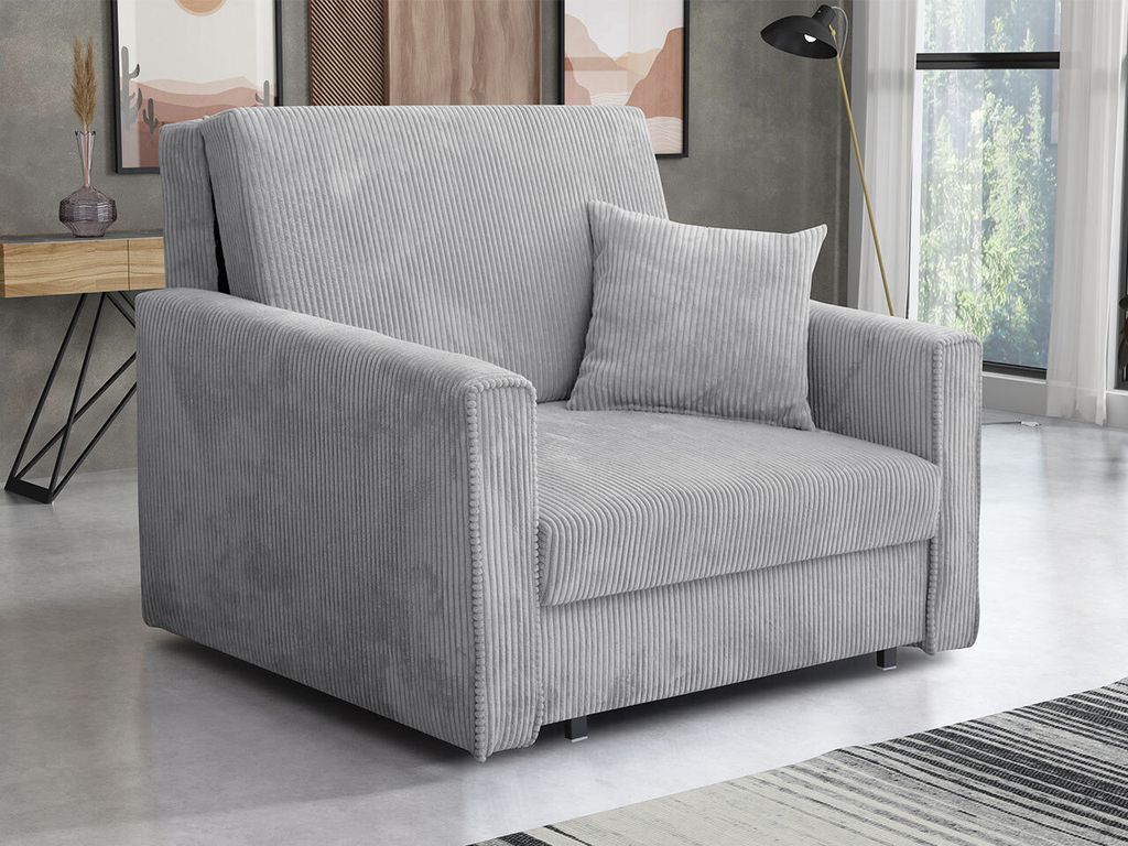 A light gray corduroy sofa is shown in a room with a wooden side table and artwork in the background.