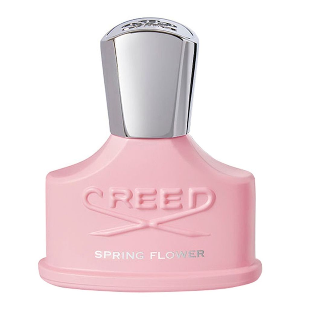 A product shot of a pink perfume bottle with a silver cap.