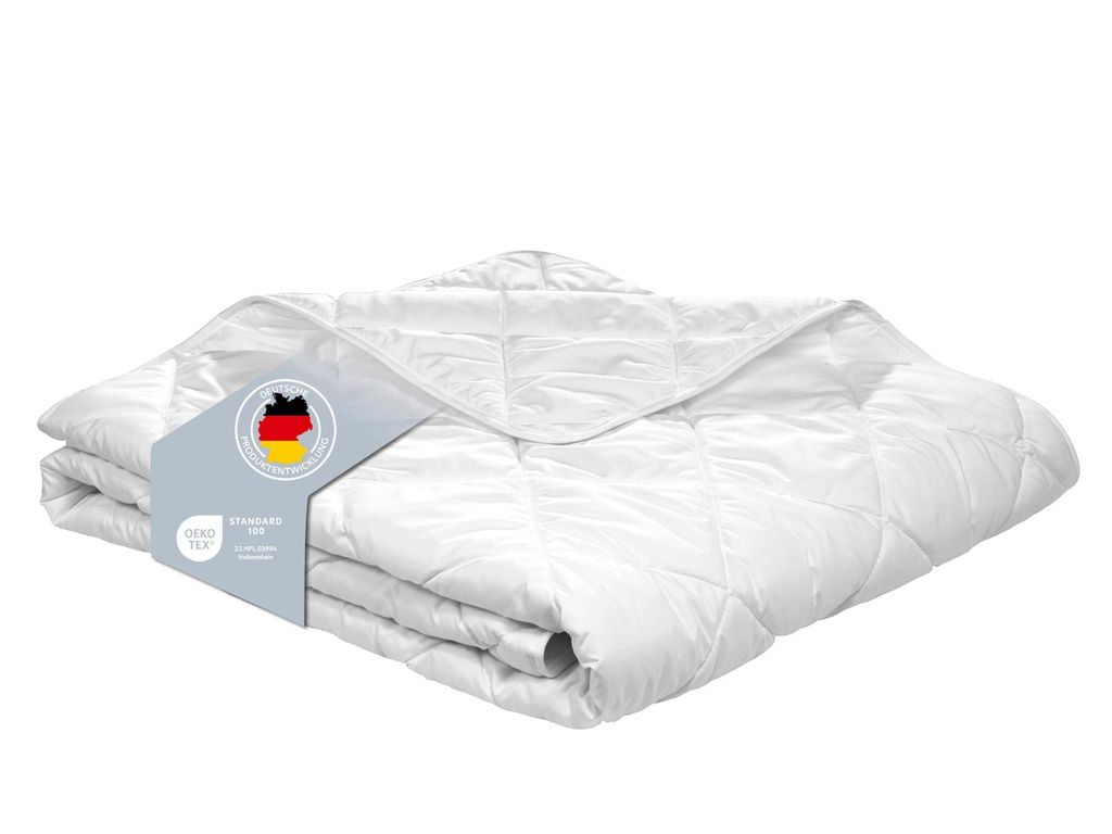 A folded white duvet is presented on a white background with a product tag attached.