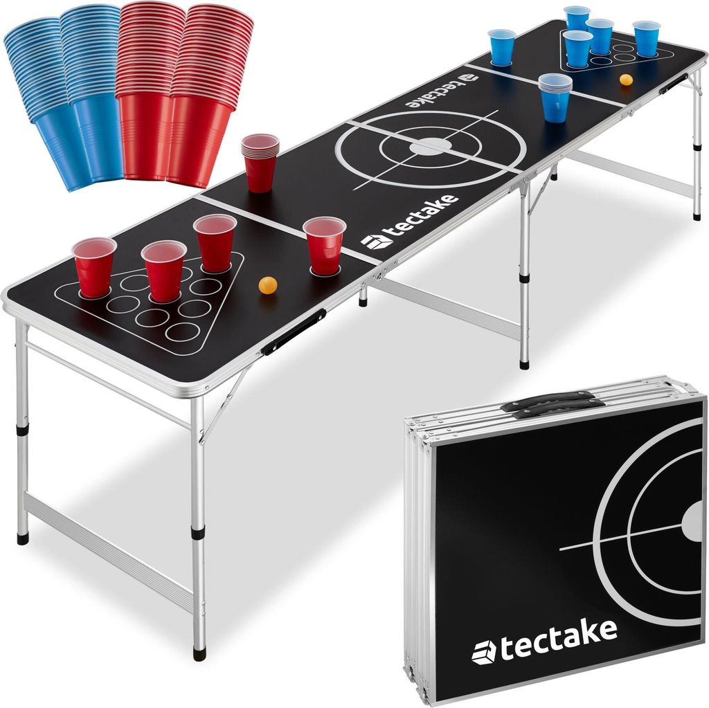 A beer pong table set up with cups and balls, and a folded table in the foreground.