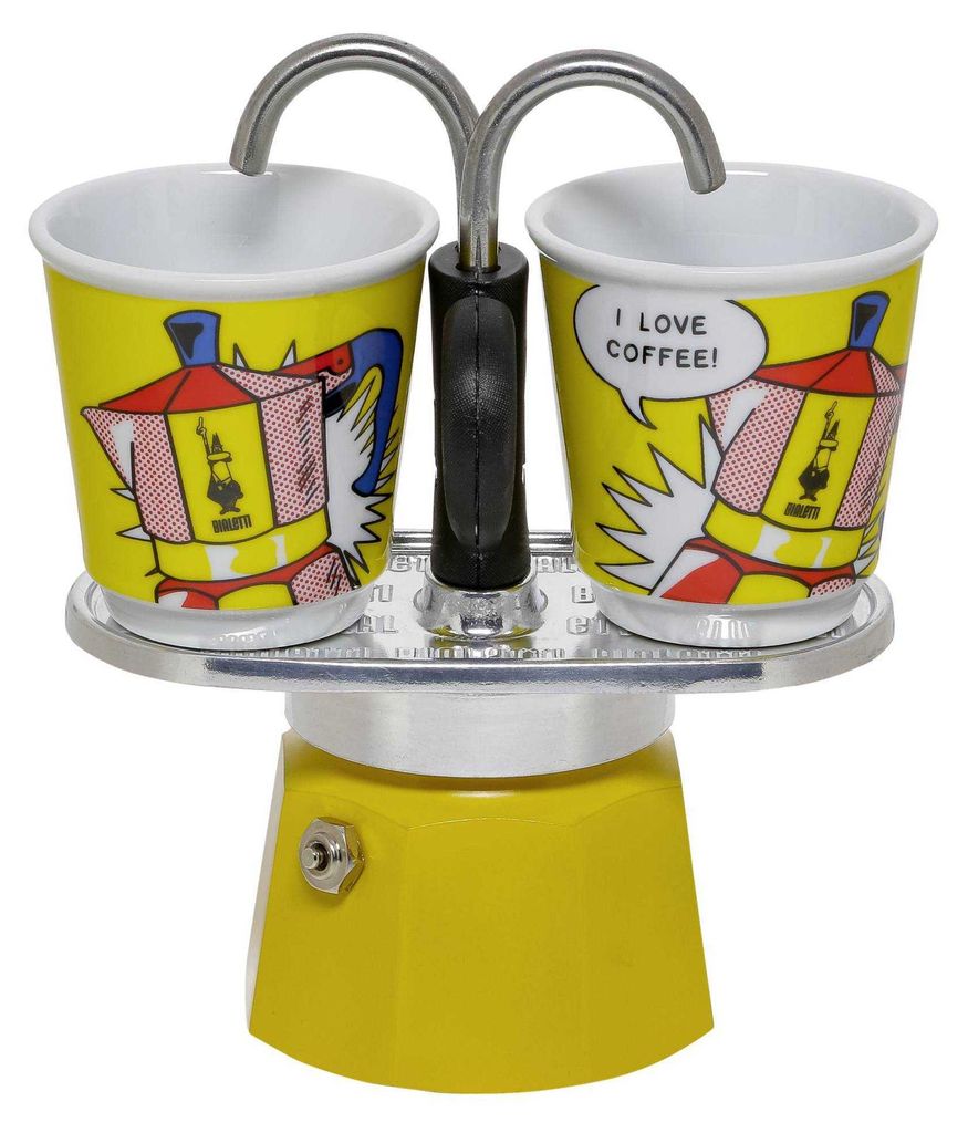 A Bialetti MINI EXPRESS Moka pot set with two cups, featuring pop art-style graphics.