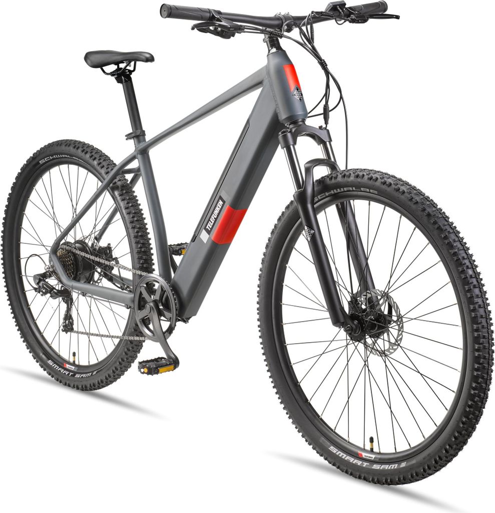 A studio shot of a grey electric mountain bike against a white background.