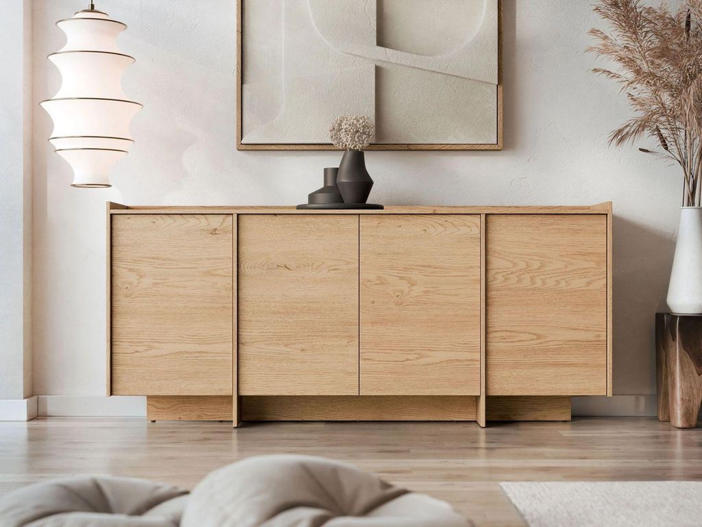 A modern living room with a wooden sideboard, a large abstract painting on the wall, and a floor lamp.