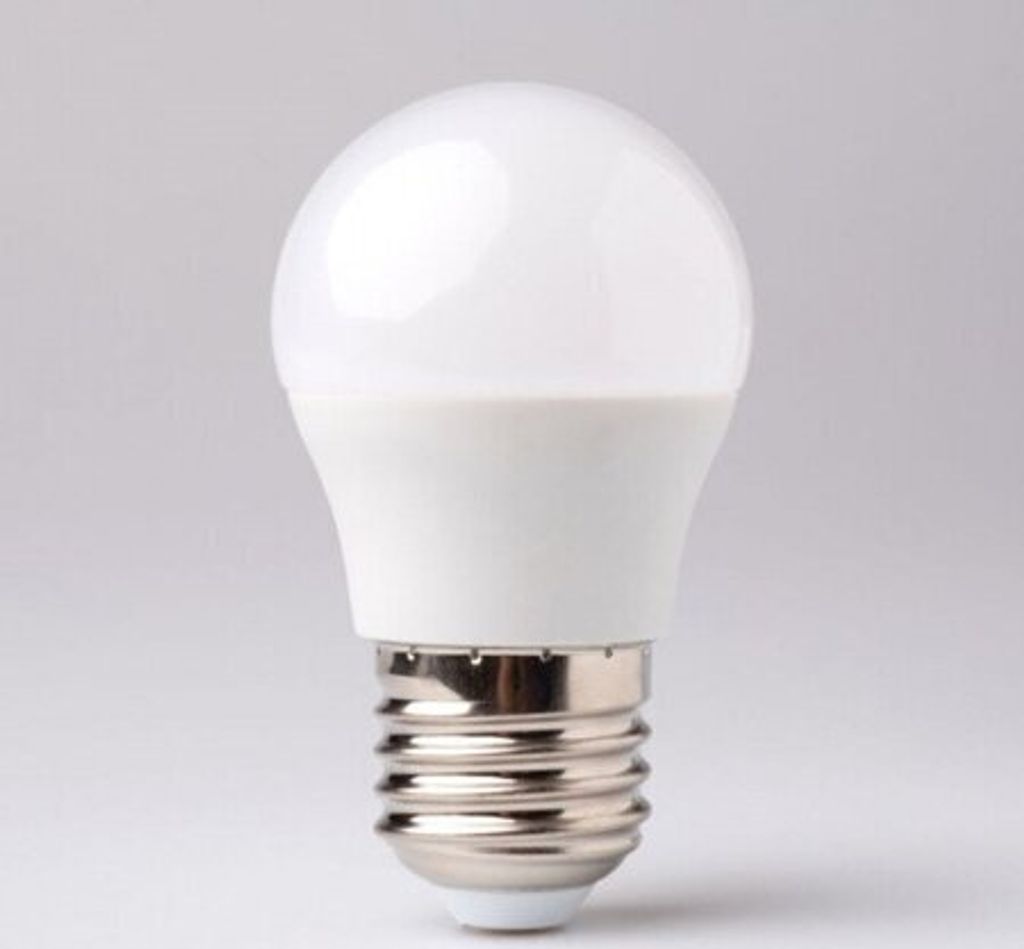 A white LED light bulb with a silver screw base against a light gray background.
