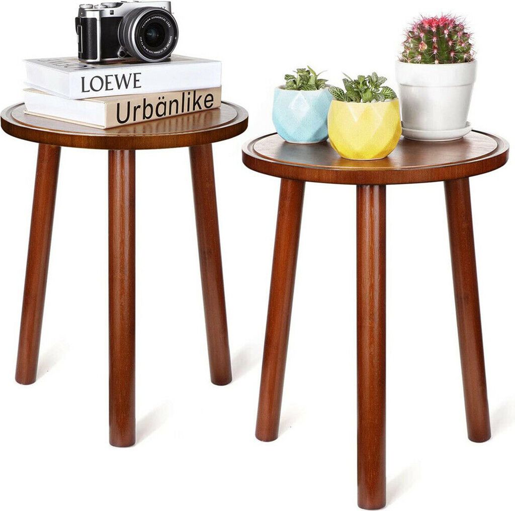 Two wooden side tables with decorative items on top.