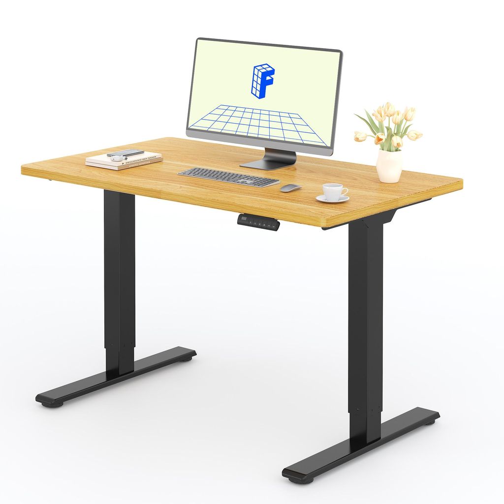 A height-adjustable desk with a monitor, keyboard, mouse, and a vase of flowers.