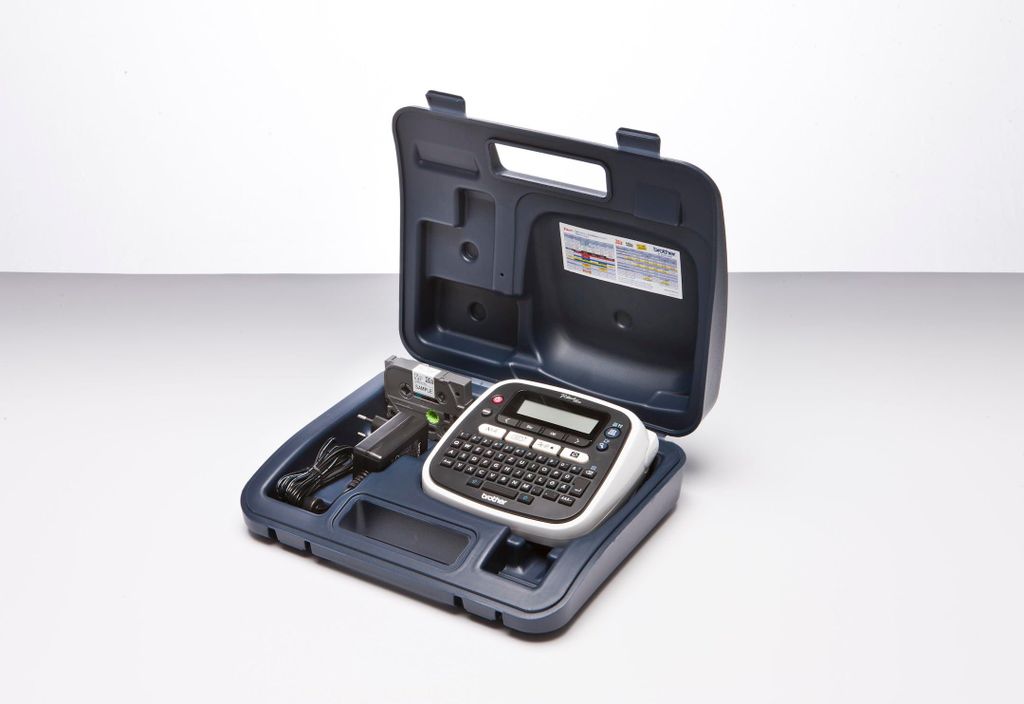 A Brother P-touch D200BWVP label maker is shown inside its carrying case, along with its power adapter and a starter tape cassette.