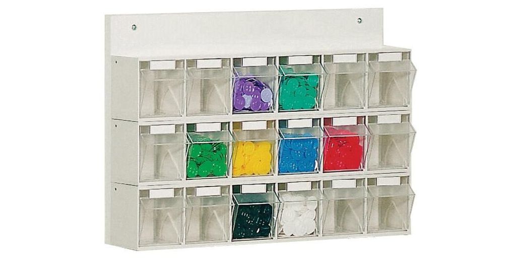 A white wall-mounted organizer with 18 clear compartments, each containing colored material.