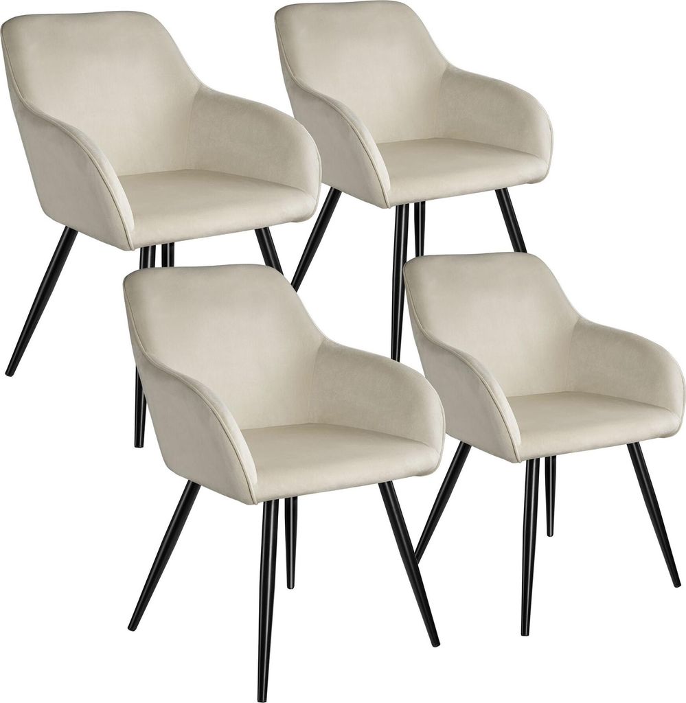 Four cream-colored dining chairs with black legs are arranged in a staggered formation against a white background.