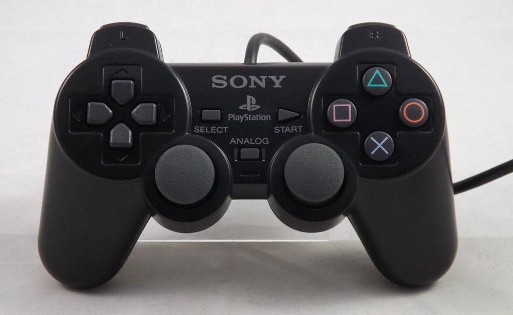 A black Sony PlayStation 2 DualShock controller is shown from a front-facing, slightly elevated angle against a white background.
