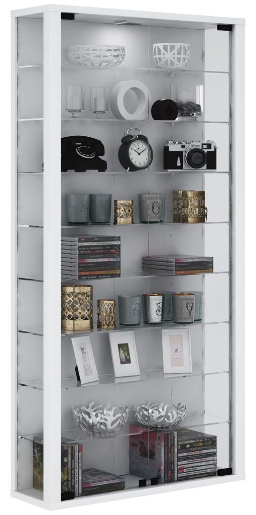 A white display cabinet filled with various decorative items and media.
