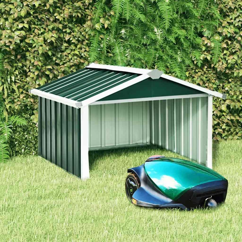 A green and white mower garage with a green robotic lawn mower in front of it, set against a backdrop of lush green foliage.