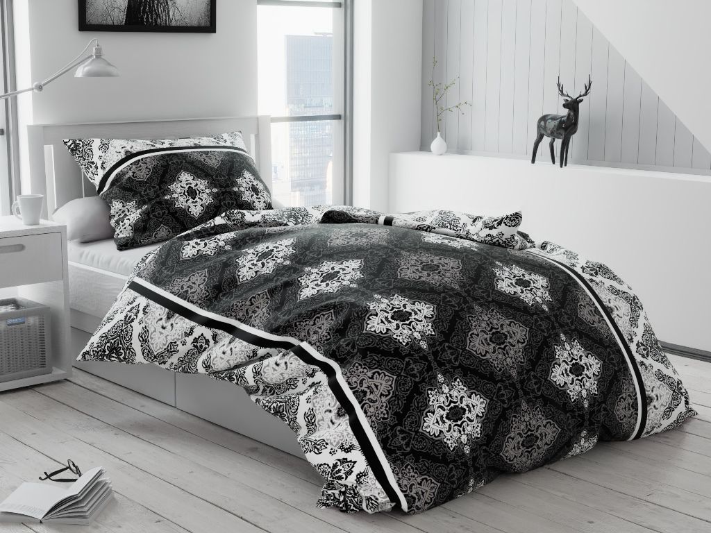 A bedroom scene with a bed made up with gray cotton bedding.