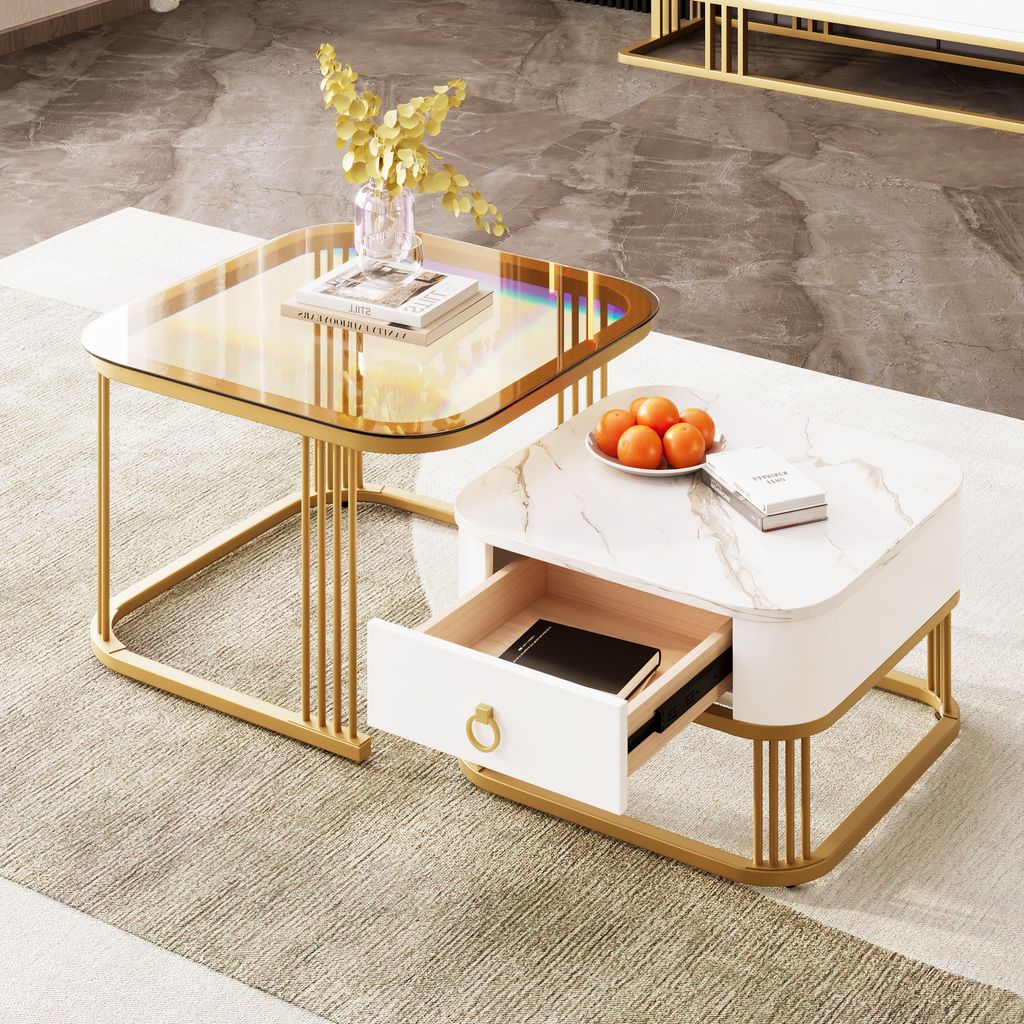 A set of two nesting coffee tables with gold metal frames and different tabletop finishes, one with a glass top and the other with a marble-look finish and a drawer.