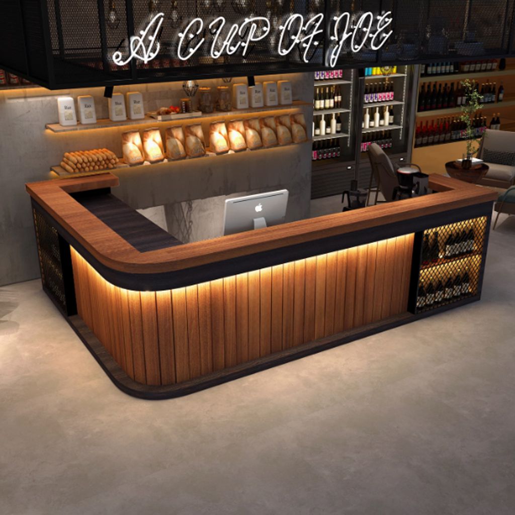 A bar counter in a commercial setting, possibly a cafe or restaurant, with shelves of products and a neon sign.