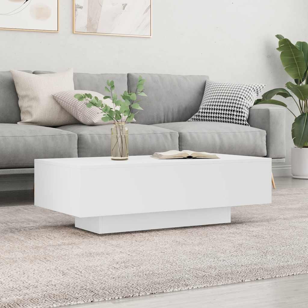 A white coffee table is placed in front of a gray sofa in a living room setting.