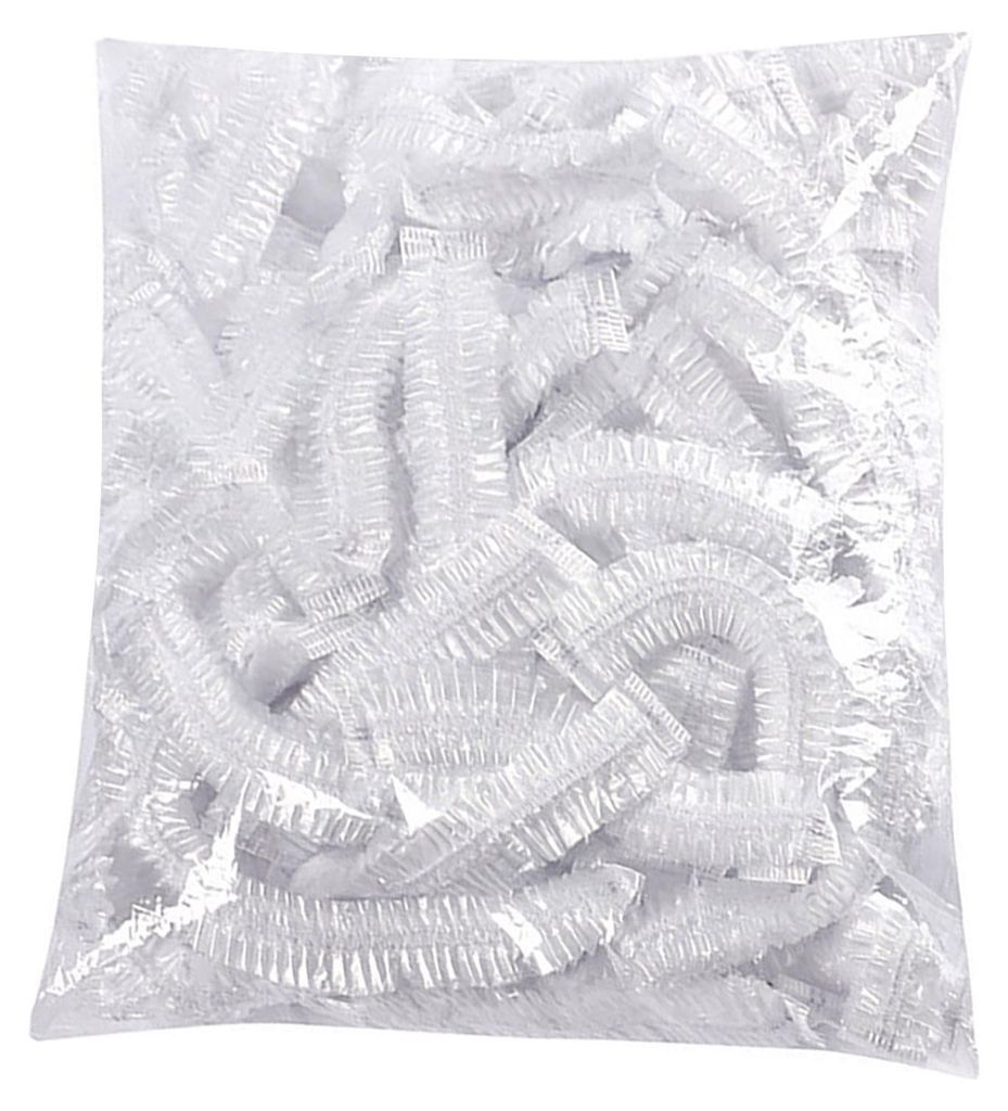 A pile of clear plastic disposable shower caps in a bag.
