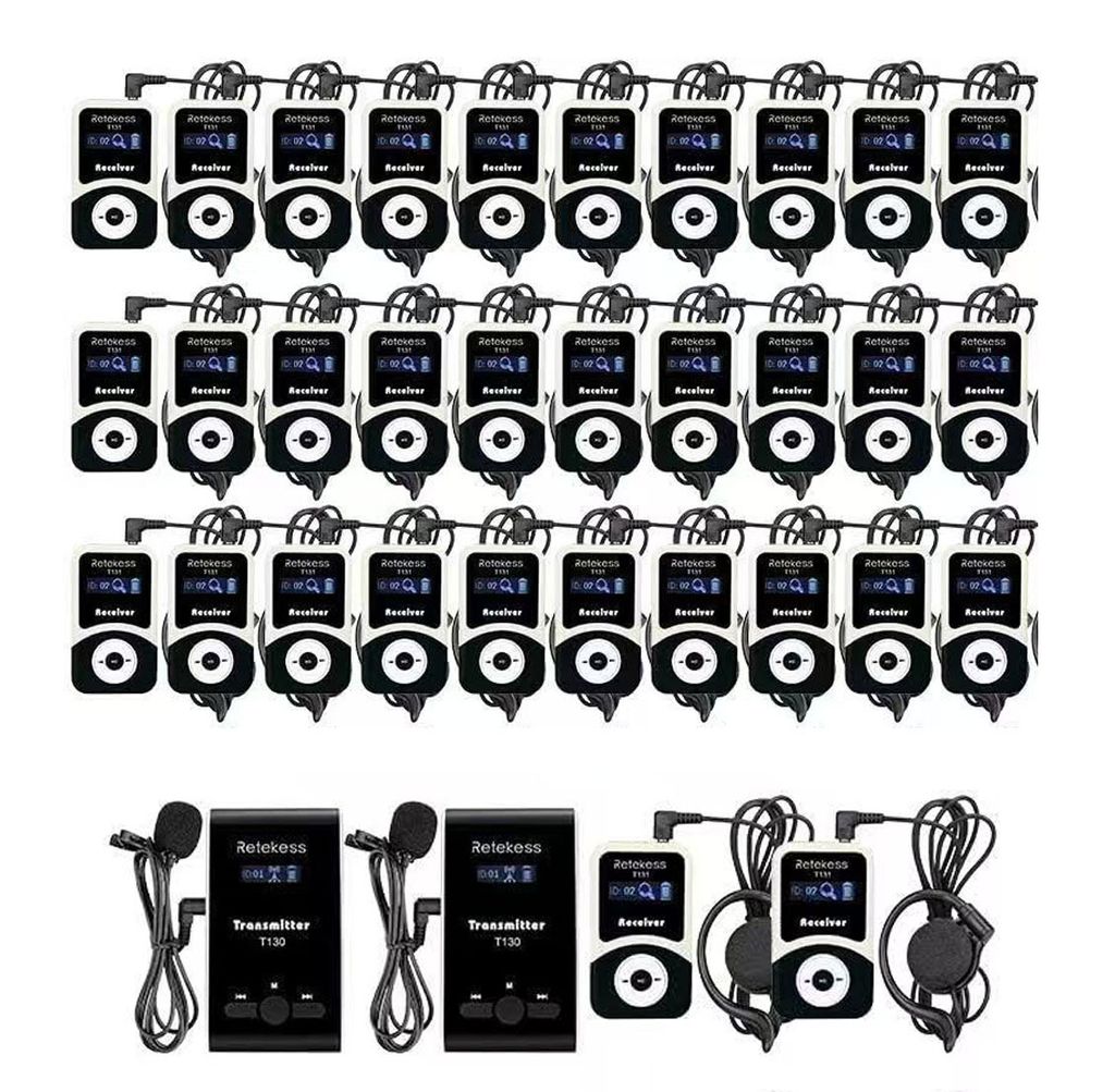 A collection of wireless tour guide system transmitters and receivers arranged in rows.