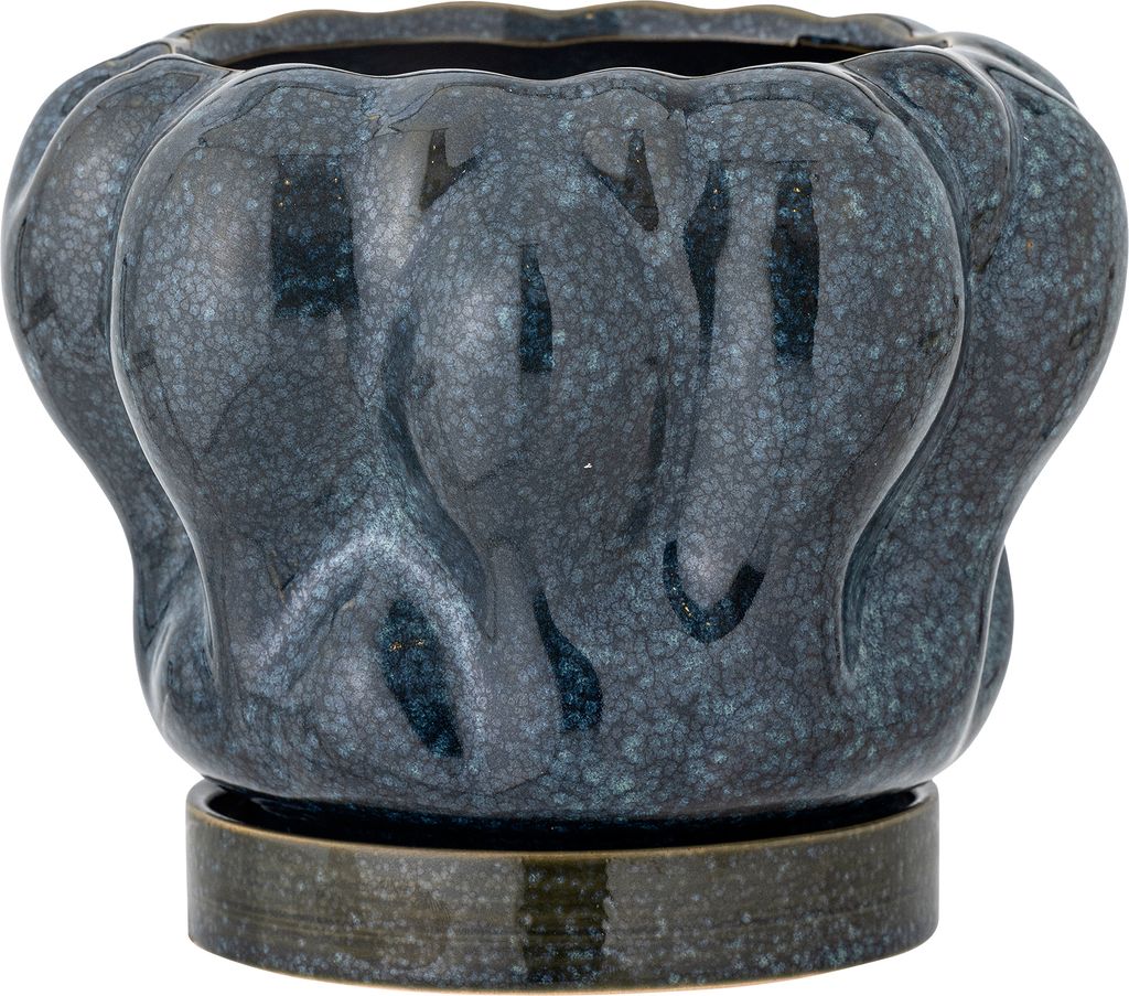 A dark blue ceramic planter with a textured, wavy design sits on a matching saucer.