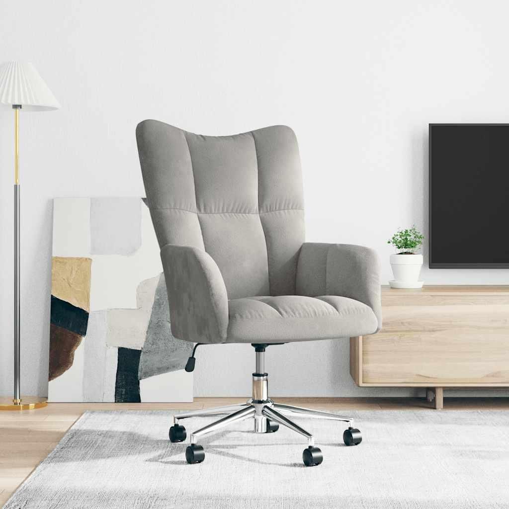 A light gray velvet armchair is shown in a room with a floor lamp and a TV stand.