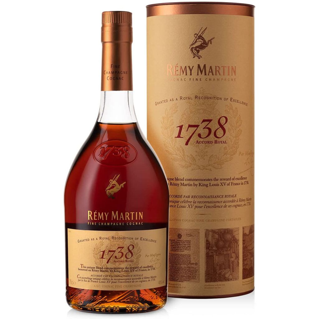 A bottle of Remy Martin 1738 Accord Royal Cognac and its cylindrical presentation box, set against a white background.