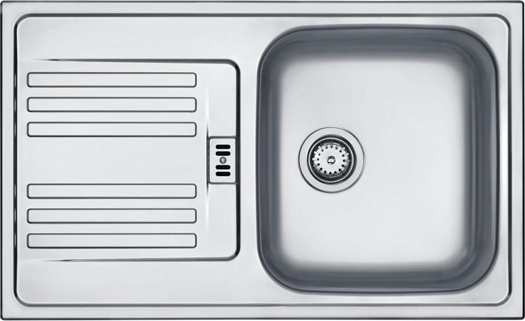 A top-down view of a stainless steel kitchen sink with a drainboard.