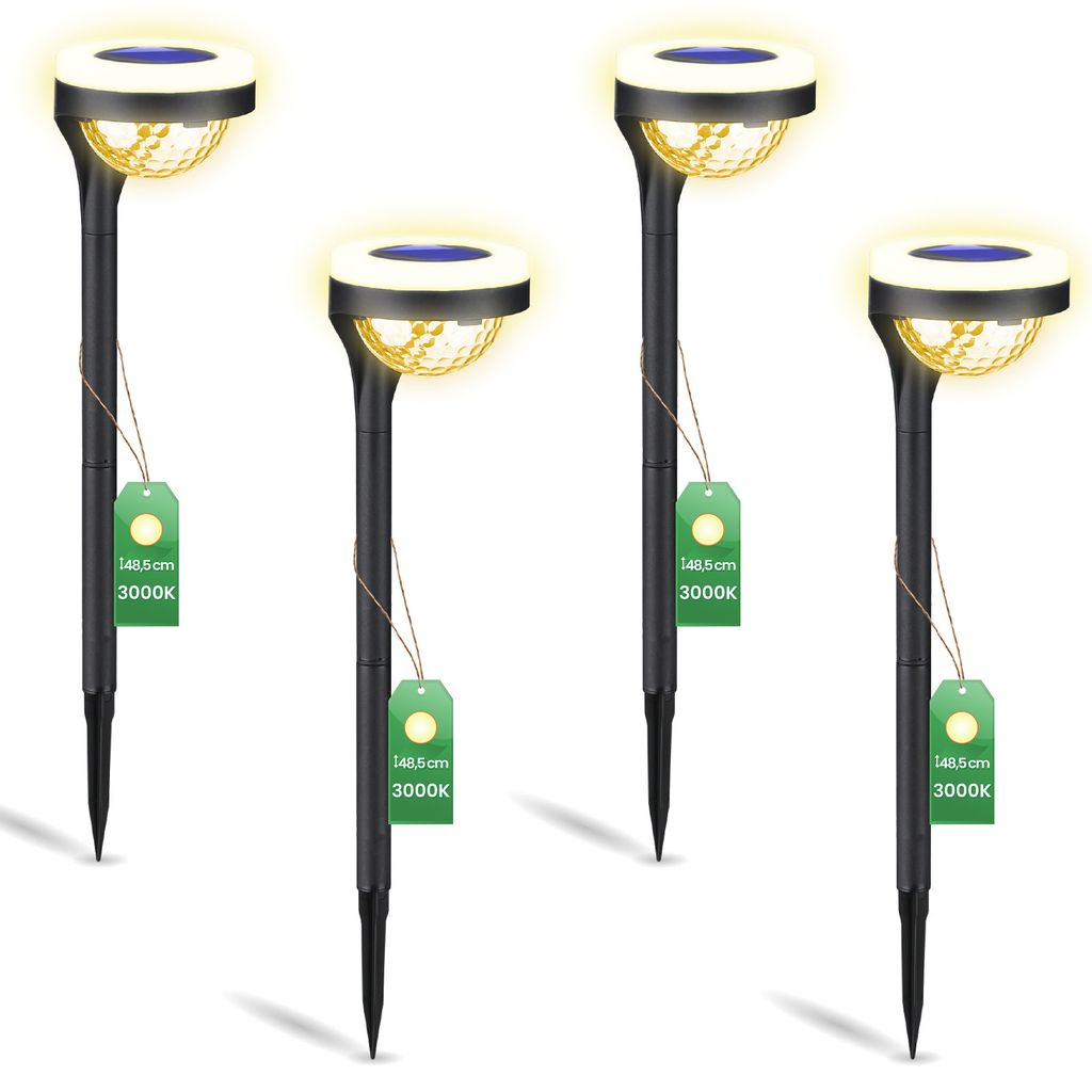 Four black solar garden lights with yellow light and blue solar panels, each with a green tag attached.