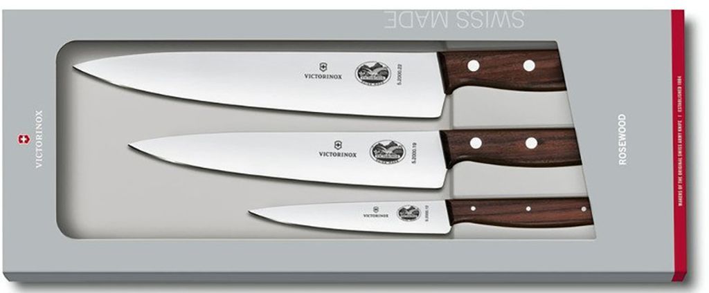 A set of three kitchen knives with wooden handles, presented in a grey box.